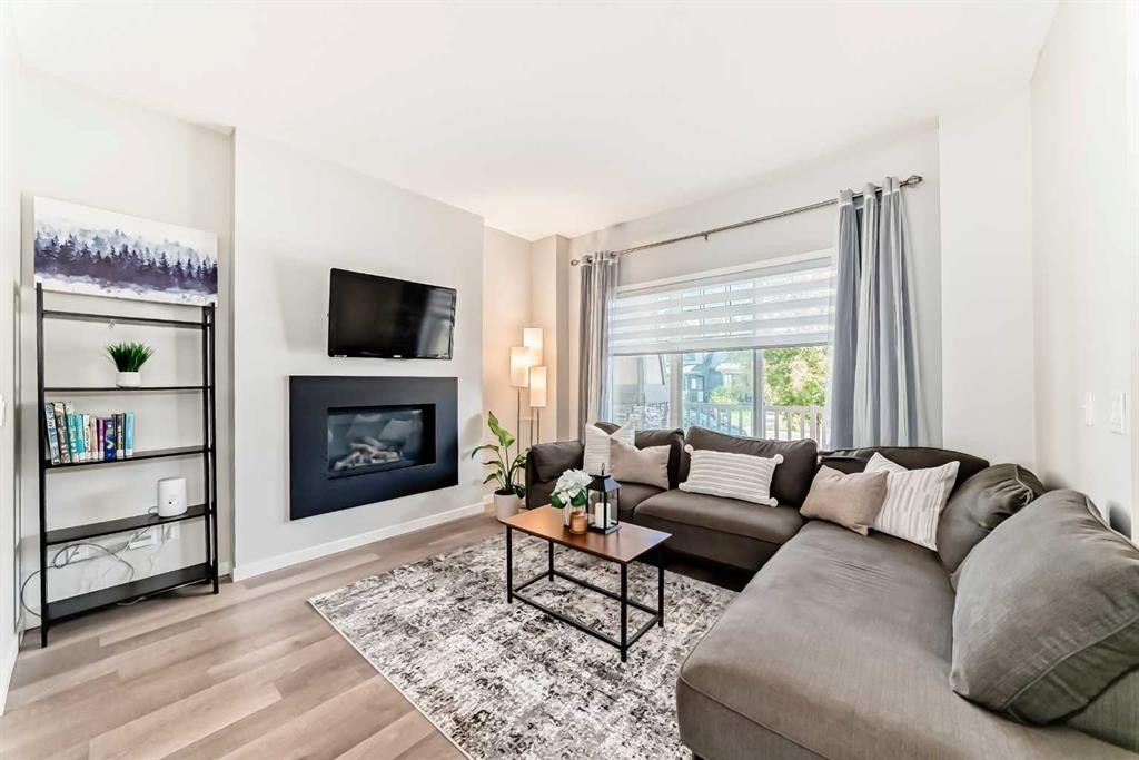 151 Copperpond Rise Se, Calgary, AB - Indoor Photo Showing Living Room With Fireplace