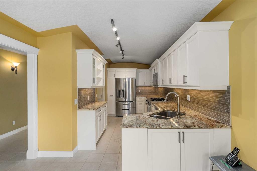 35 Prominence Path Sw, Calgary, AB - Indoor Photo Showing Kitchen With Double Sink