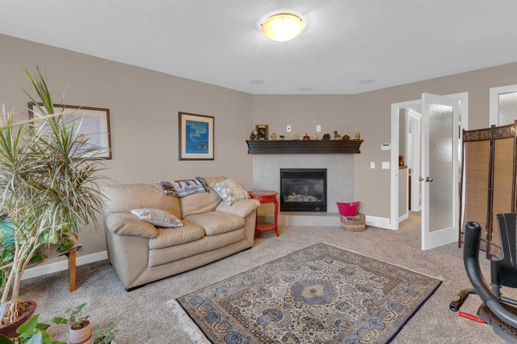 172 Ridge View Close, Cochrane, AB - Indoor Photo Showing Living Room With Fireplace