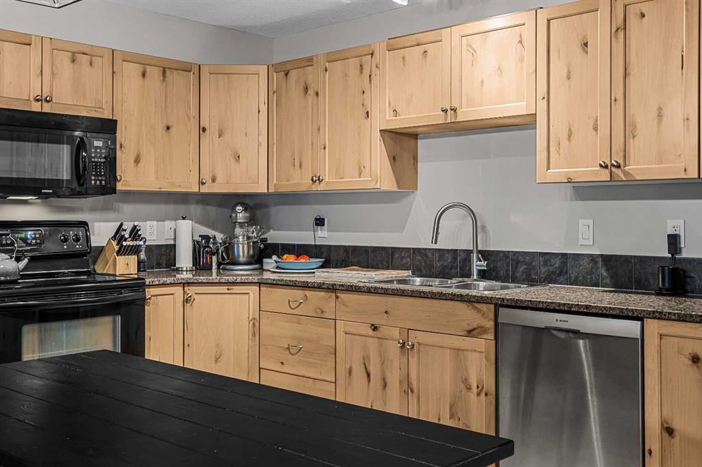 111-300 Palliser, Canmore, AB - Indoor Photo Showing Kitchen With Double Sink