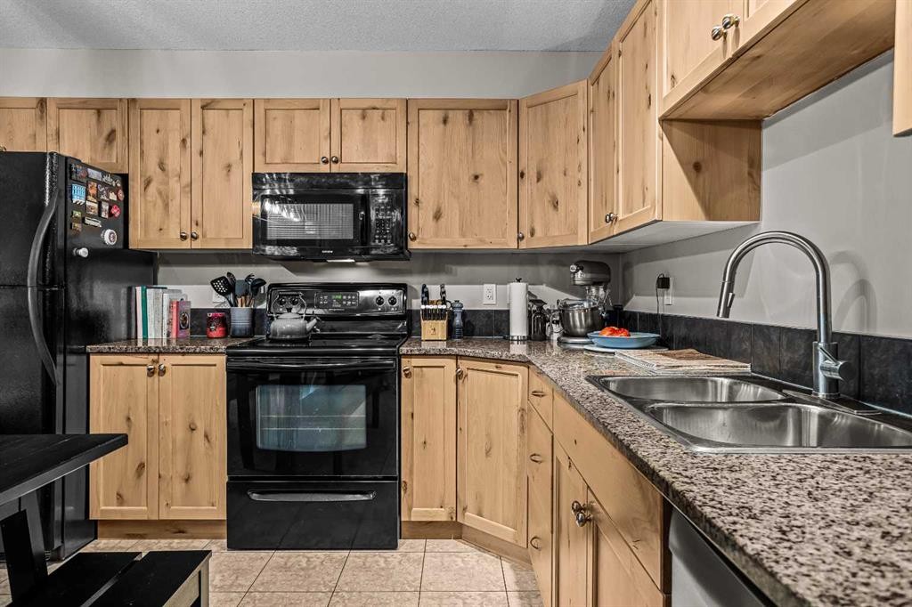 111-300 Palliser, Canmore, AB - Indoor Photo Showing Kitchen With Double Sink