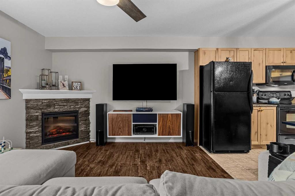 111-300 Palliser, Canmore, AB - Indoor Photo Showing Living Room With Fireplace