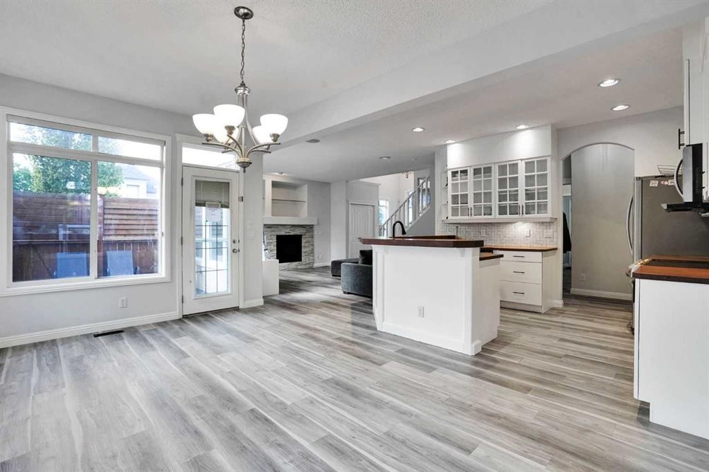 74 Cranleigh Green Se, Calgary, AB - Indoor Photo Showing Kitchen With Fireplace