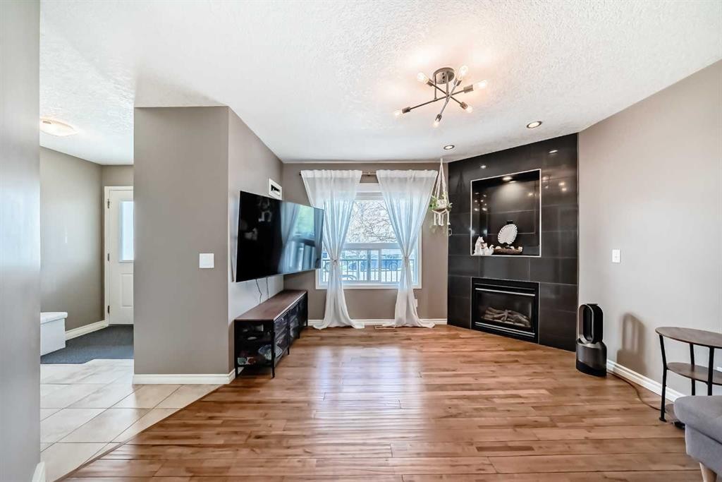 173 Eversyde Common Sw, Calgary, AB - Indoor With Fireplace
