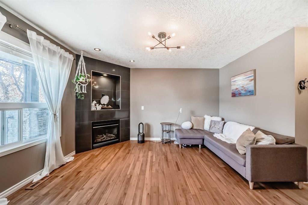 173 Eversyde Common Sw, Calgary, AB - Indoor With Fireplace
