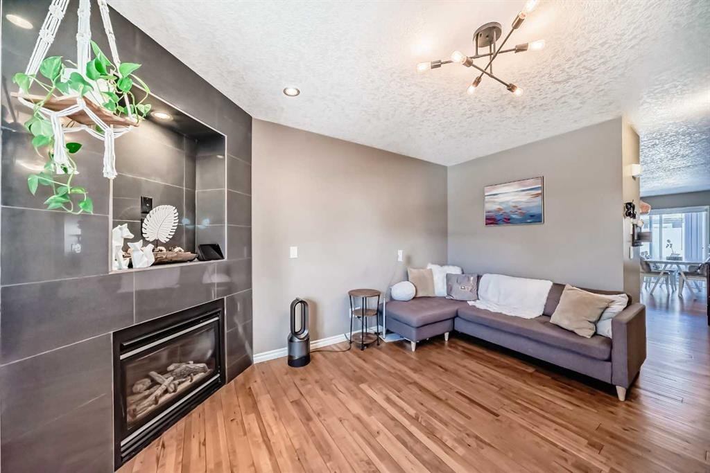 173 Eversyde Common Sw, Calgary, AB - Indoor Photo Showing Living Room With Fireplace