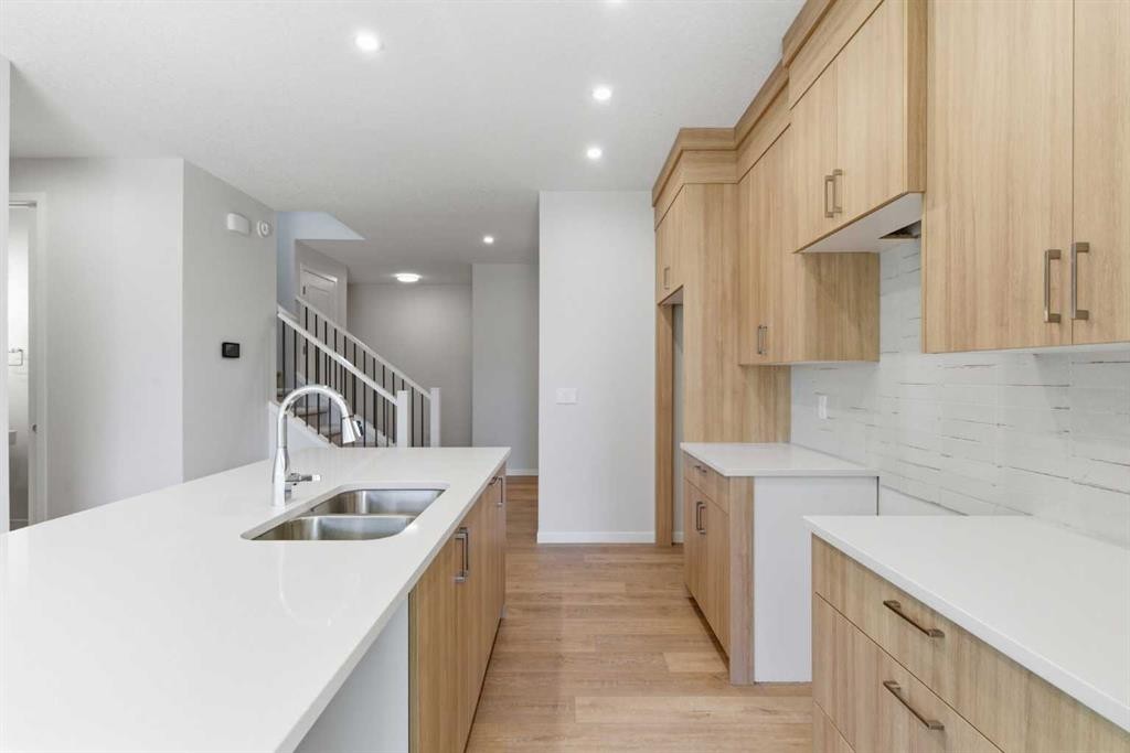 53 Snowberry Common Se, Calgary, AB - Indoor Photo Showing Kitchen With Double Sink