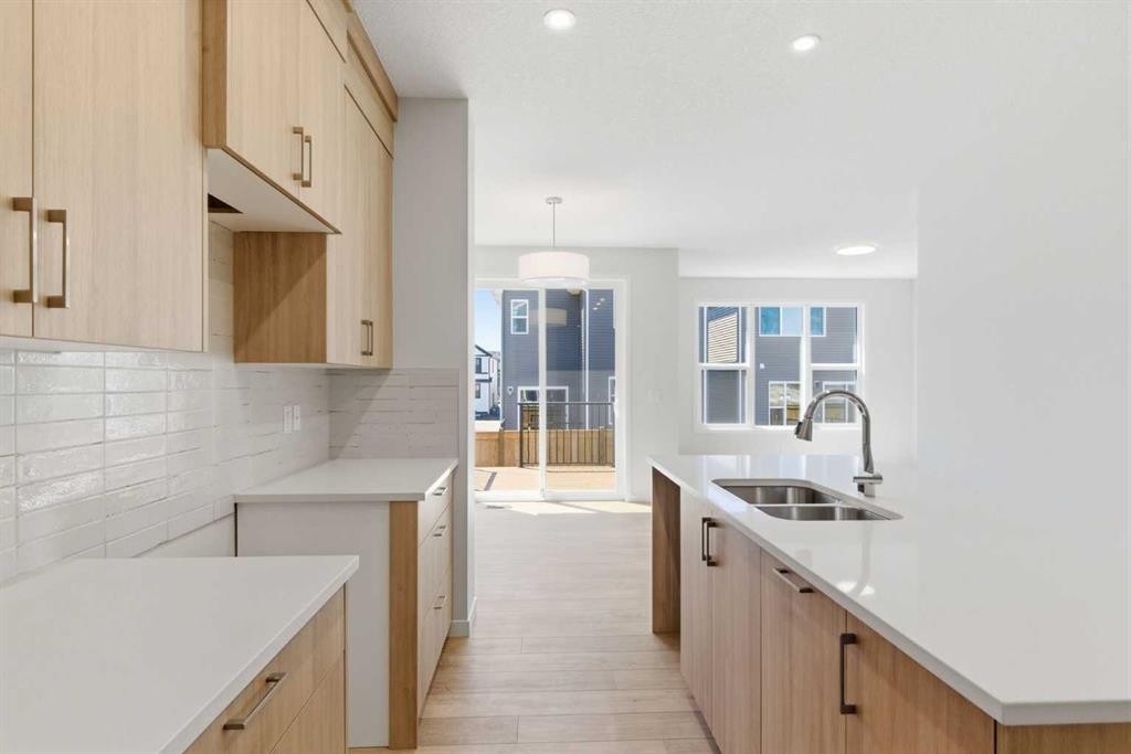 53 Snowberry Common Se, Calgary, AB - Indoor Photo Showing Kitchen With Double Sink
