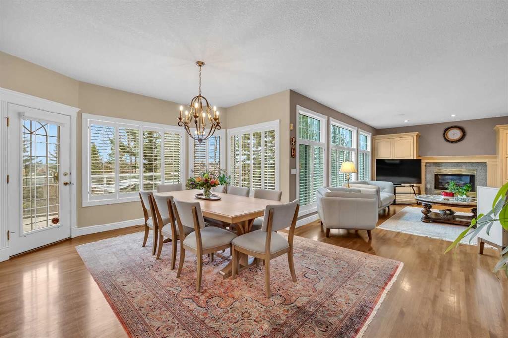 216 Evergreen Heath Sw, Calgary, AB - Indoor Photo Showing Dining Room With Fireplace