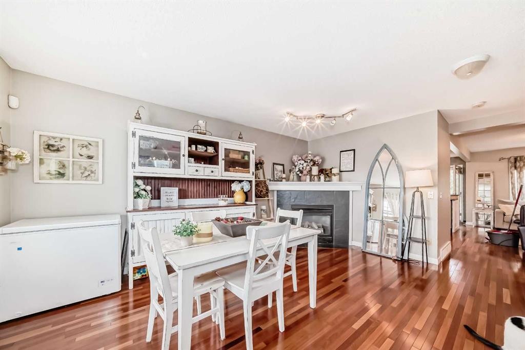 132 Hidden Hills Road Nw, Calgary, AB - Indoor Photo Showing Dining Room With Fireplace