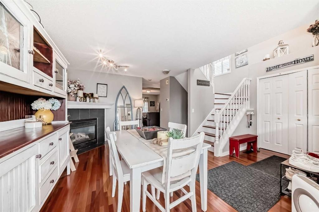132 Hidden Hills Road Nw, Calgary, AB - Indoor Photo Showing Dining Room With Fireplace