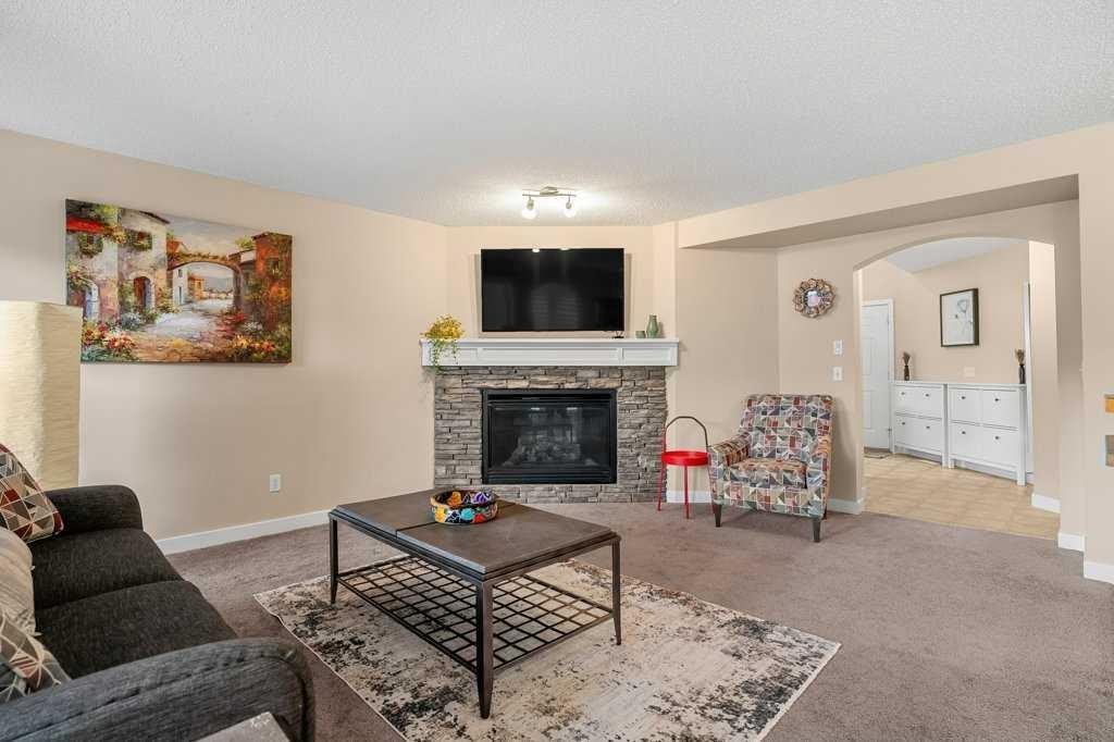 140 Panamount Circle Nw, Calgary, AB - Indoor Photo Showing Living Room With Fireplace
