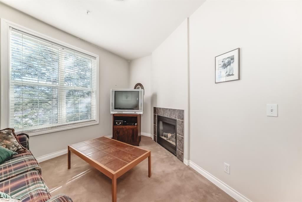 261-3000 Marda Link Sw, Calgary, AB - Indoor Photo Showing Living Room With Fireplace