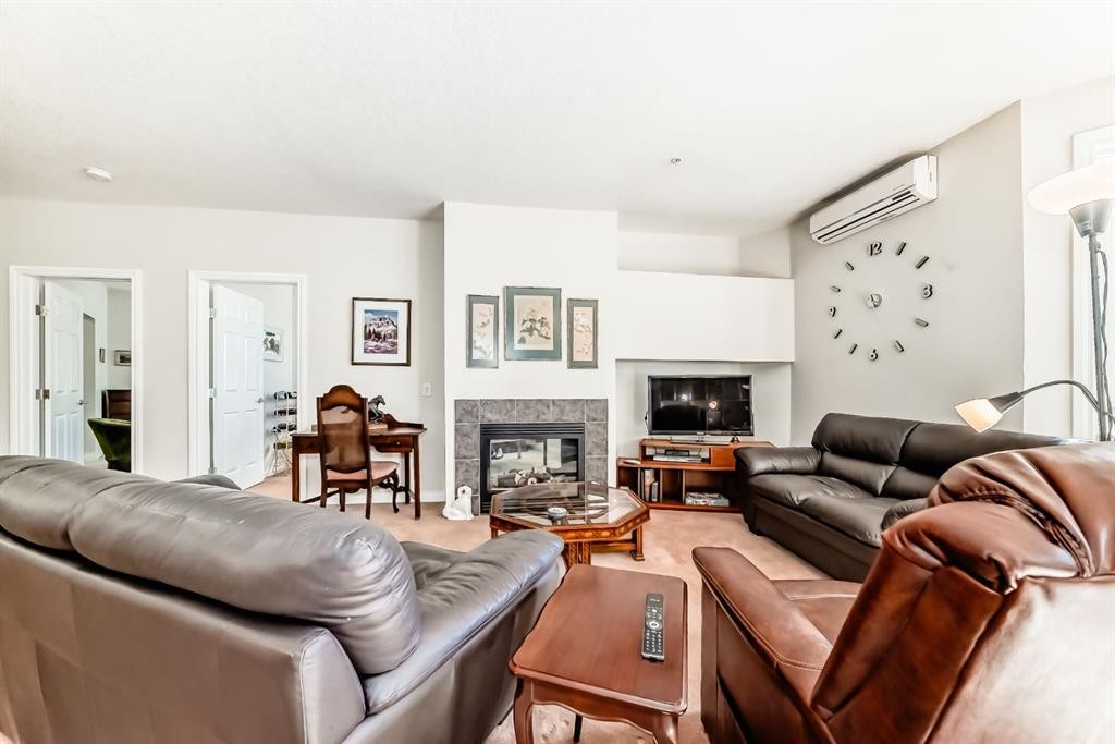 261-3000 Marda Link Sw, Calgary, AB - Indoor Photo Showing Living Room With Fireplace
