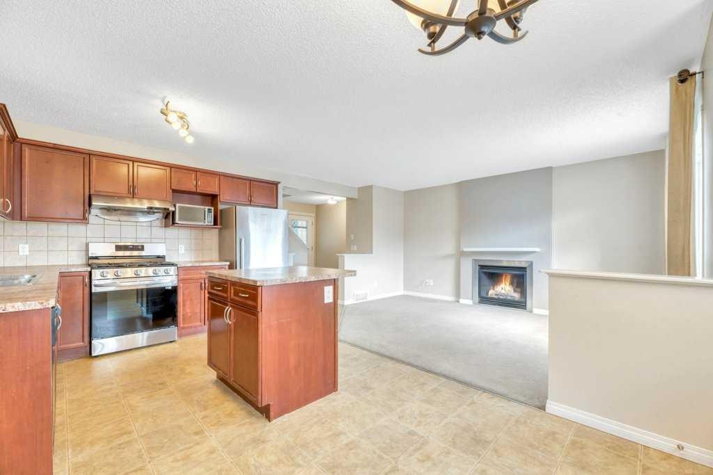 126 Covebrook Place Ne, Calgary, AB - Indoor Photo Showing Kitchen With Fireplace With Double Sink