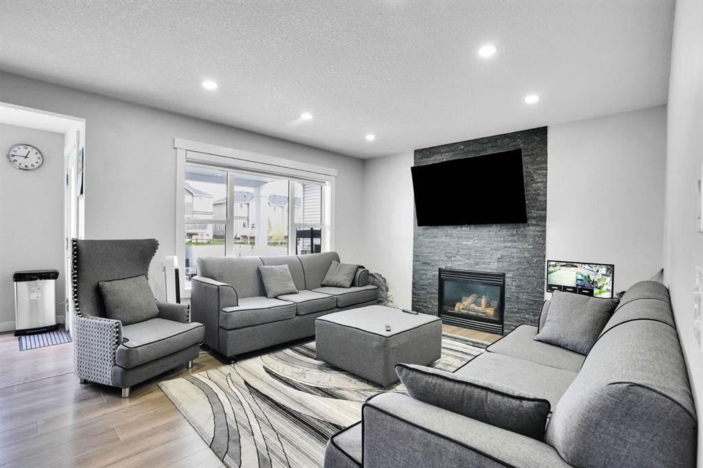 63 Saddlemont Crescent Ne, Calgary, AB - Indoor Photo Showing Living Room With Fireplace