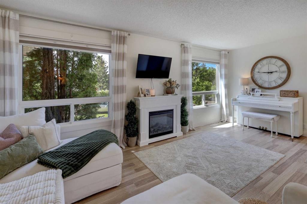 8320 Centre Street Ne, Calgary, AB - Indoor Photo Showing Living Room With Fireplace
