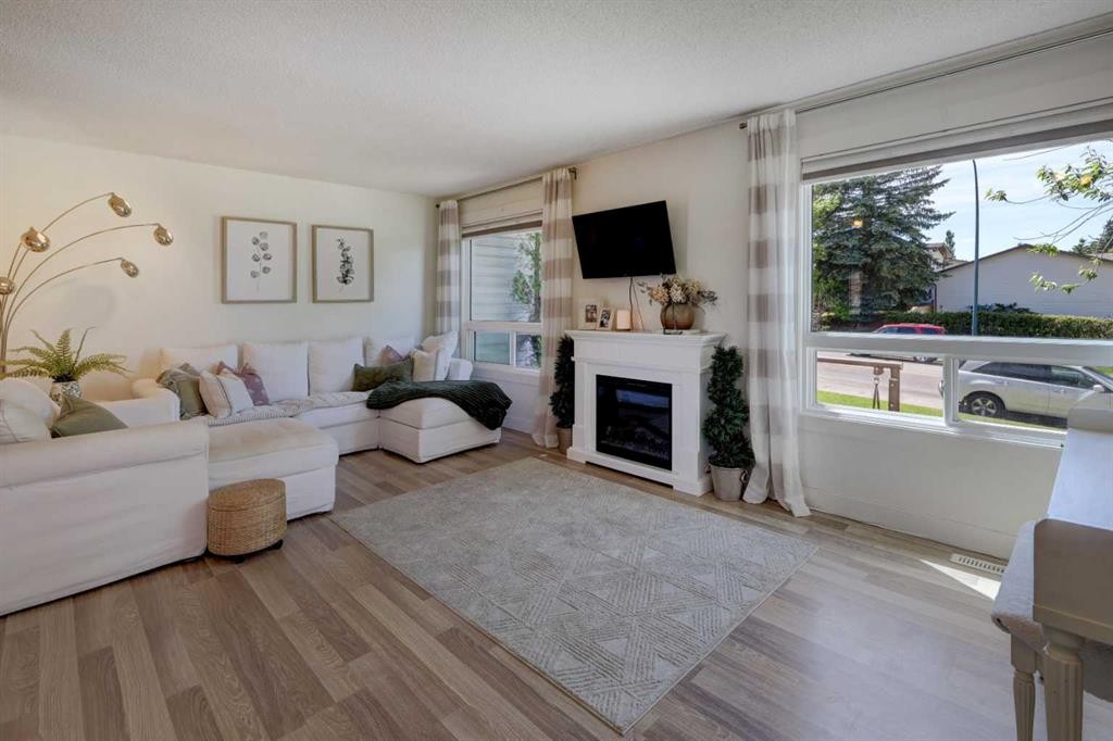 8320 Centre Street Ne, Calgary, AB - Indoor Photo Showing Living Room With Fireplace