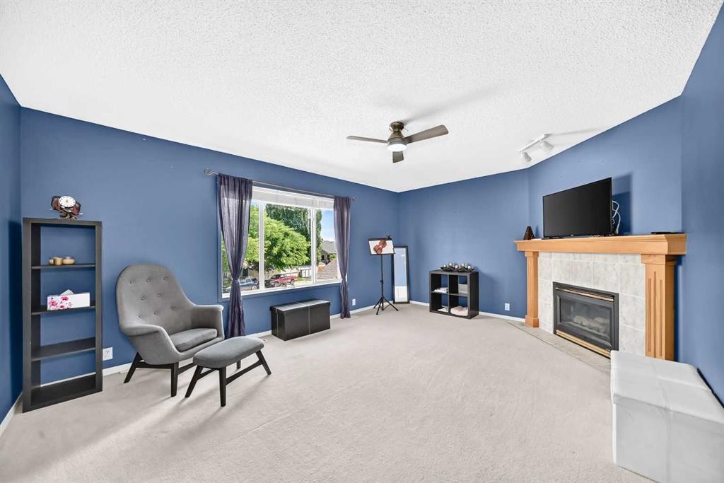 220 Shawbrooke Manor Sw, Calgary, AB - Indoor Photo Showing Living Room With Fireplace