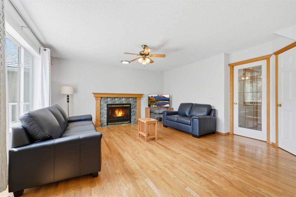 67 Sienna Heights Way Sw, Calgary, AB - Indoor Photo Showing Living Room With Fireplace
