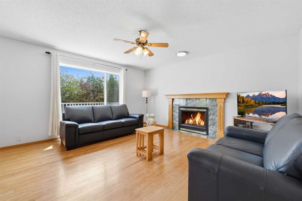 67 Sienna Heights Way Sw, Calgary, AB - Indoor Photo Showing Living Room With Fireplace