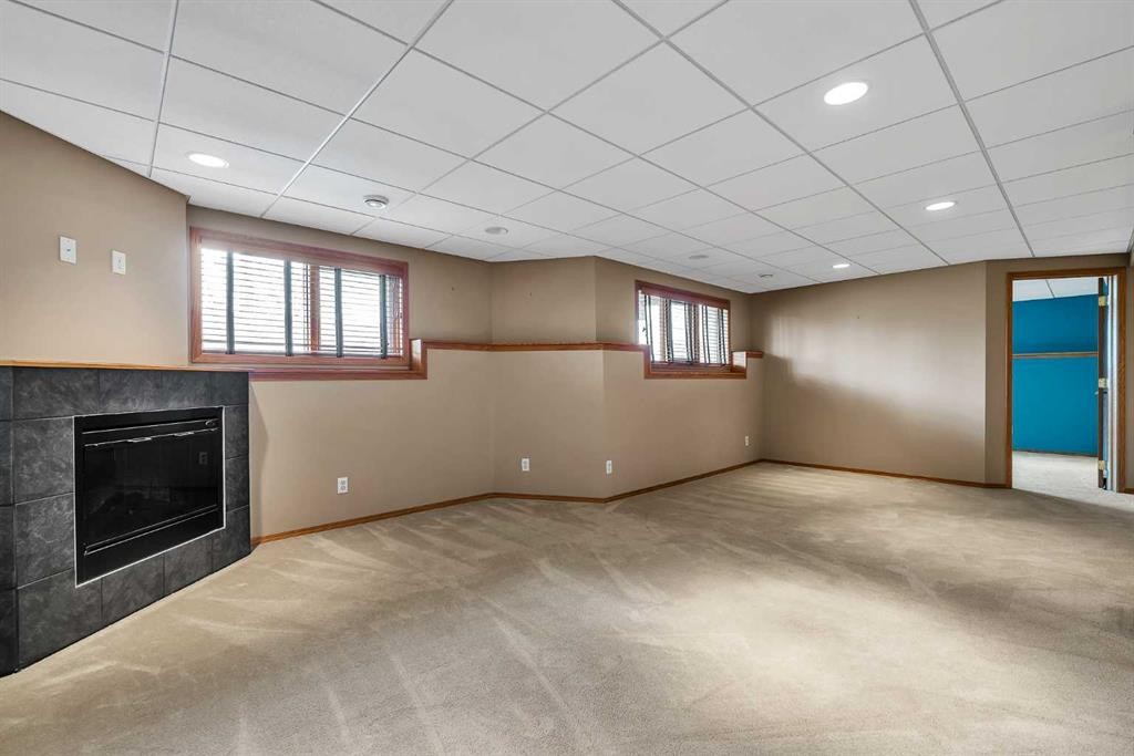 8 Edgepark Villas Nw, Calgary, AB - Indoor Photo Showing Basement With Fireplace