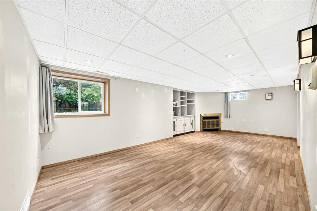 42 Cardiff Drive Nw, Calgary, AB - Indoor Photo Showing Other Room With Fireplace
