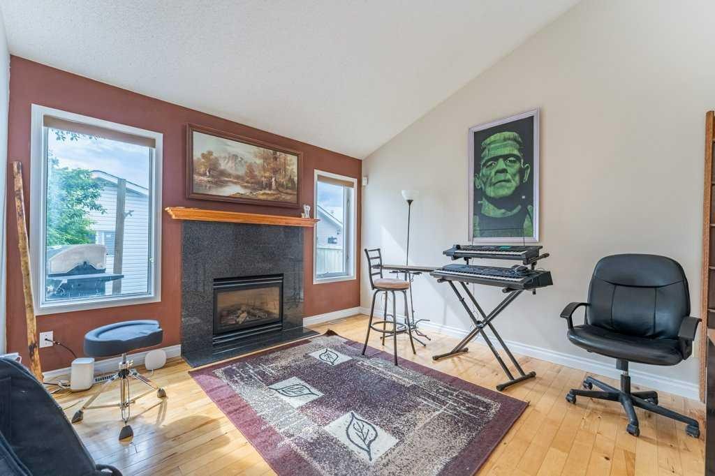 250 Mt Lorette Close Se, Calgary, AB - Indoor Photo Showing Living Room With Fireplace