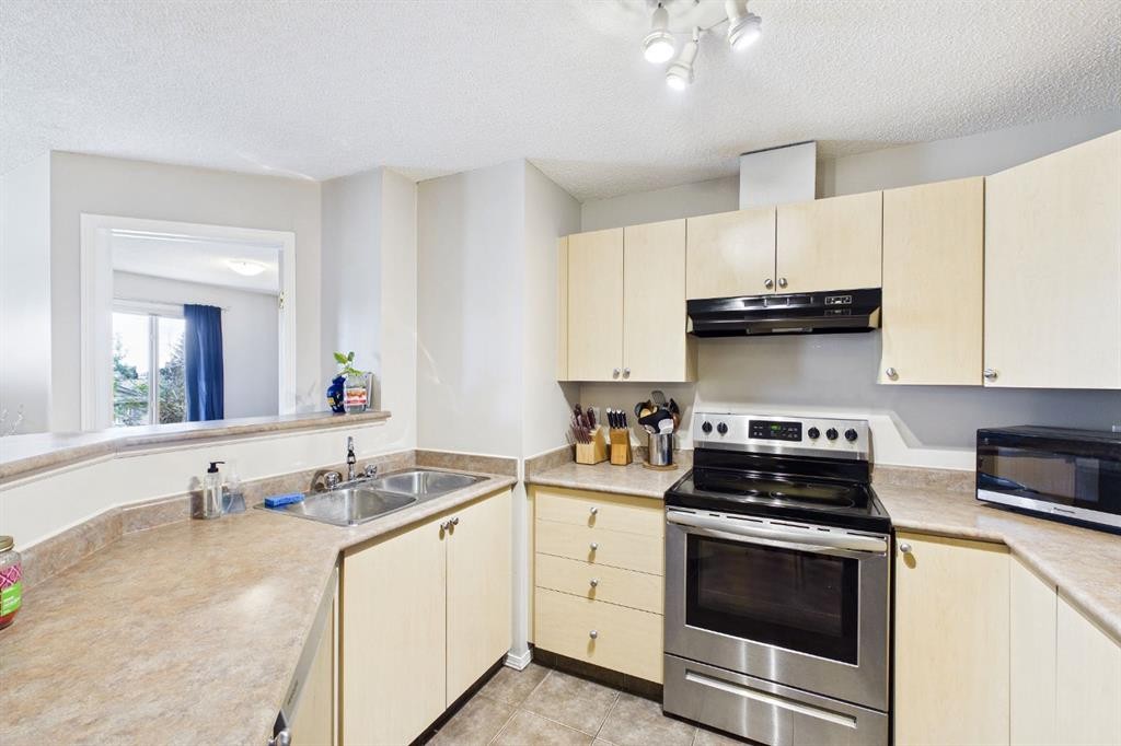 2305-2371 Eversyde Avenue Sw, Calgary, AB - Indoor Photo Showing Kitchen With Double Sink
