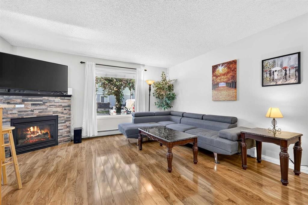 105-5105 Valleyview Park Se, Calgary, AB - Indoor Photo Showing Living Room With Fireplace