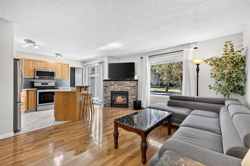 105-5105 Valleyview Park Se, Calgary, AB - Indoor Photo Showing Living Room With Fireplace