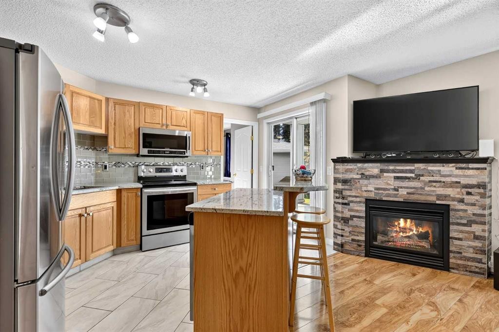 105-5105 Valleyview Park Se, Calgary, AB - Indoor Photo Showing Kitchen With Fireplace