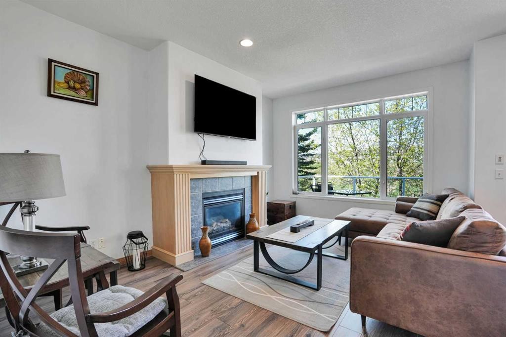 6 Discovery Woods Villas Sw, Calgary, AB - Indoor Photo Showing Living Room With Fireplace