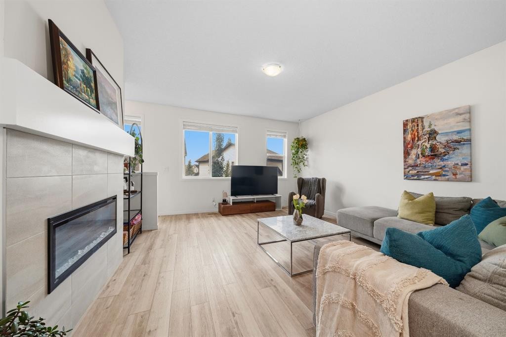 418 Copperstone Manor Se, Calgary, AB - Indoor Photo Showing Living Room With Fireplace