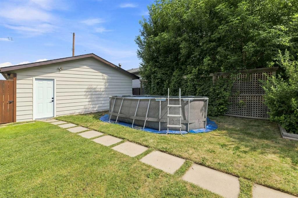 331 Queensland Circle Se, Calgary, AB - Outdoor With Above Ground Pool