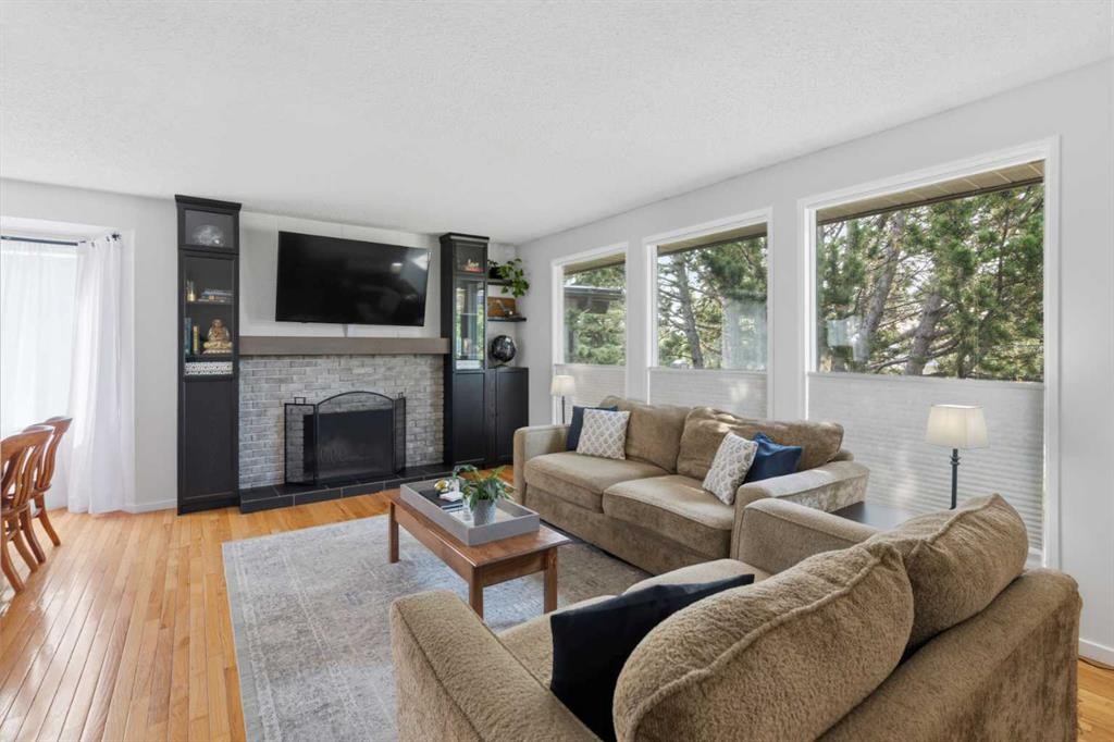 331 Queensland Circle Se, Calgary, AB - Indoor Photo Showing Living Room With Fireplace