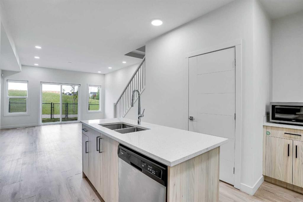 106-116 Saddlestone Heath Ne, Calgary, AB - Indoor Photo Showing Kitchen With Double Sink