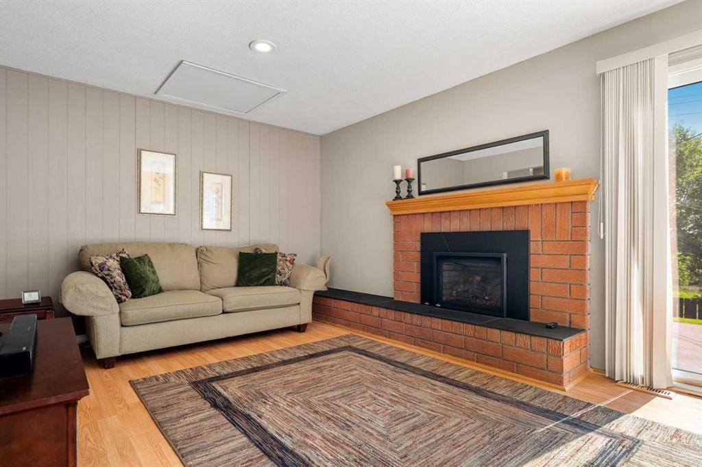 1102 Lake Christina Way Se, Calgary, AB - Indoor Photo Showing Living Room With Fireplace