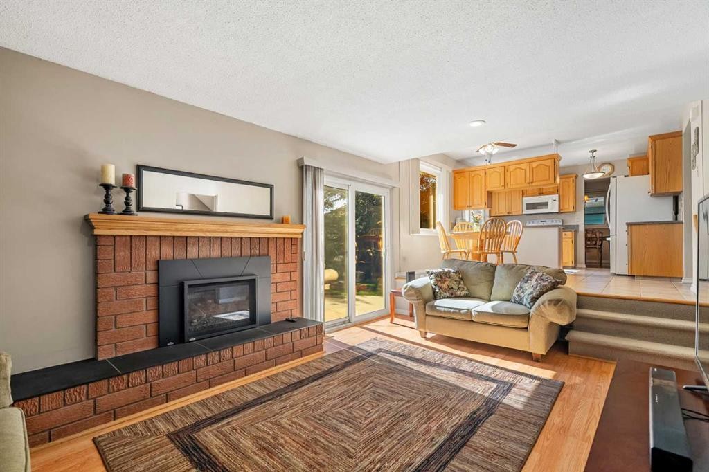 1102 Lake Christina Way Se, Calgary, AB - Indoor Photo Showing Living Room With Fireplace