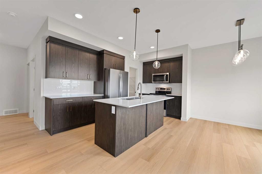 38 Waterford Mews, Chestermere, AB - Indoor Photo Showing Kitchen With Upgraded Kitchen