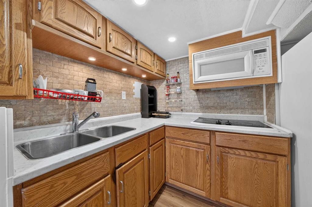 202 Silverado Range Place Sw, Calgary, AB - Indoor Photo Showing Kitchen With Double Sink