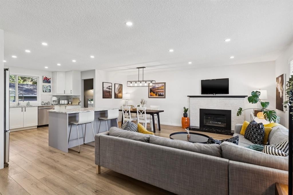 716 Cantree Road Sw, Calgary, AB - Indoor Photo Showing Living Room With Fireplace