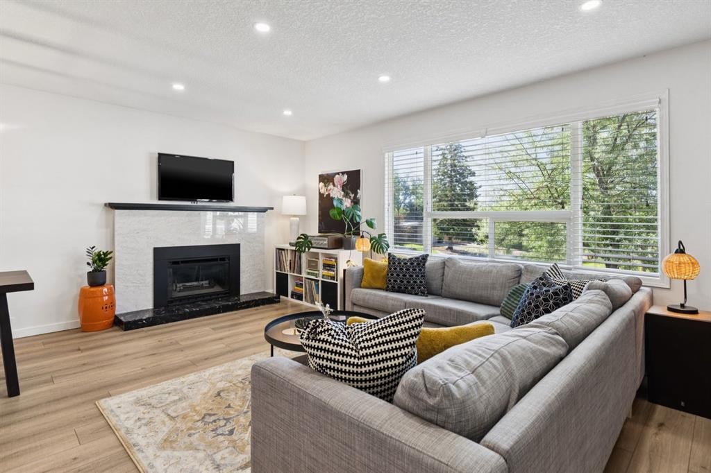 716 Cantree Road Sw, Calgary, AB - Indoor Photo Showing Living Room With Fireplace