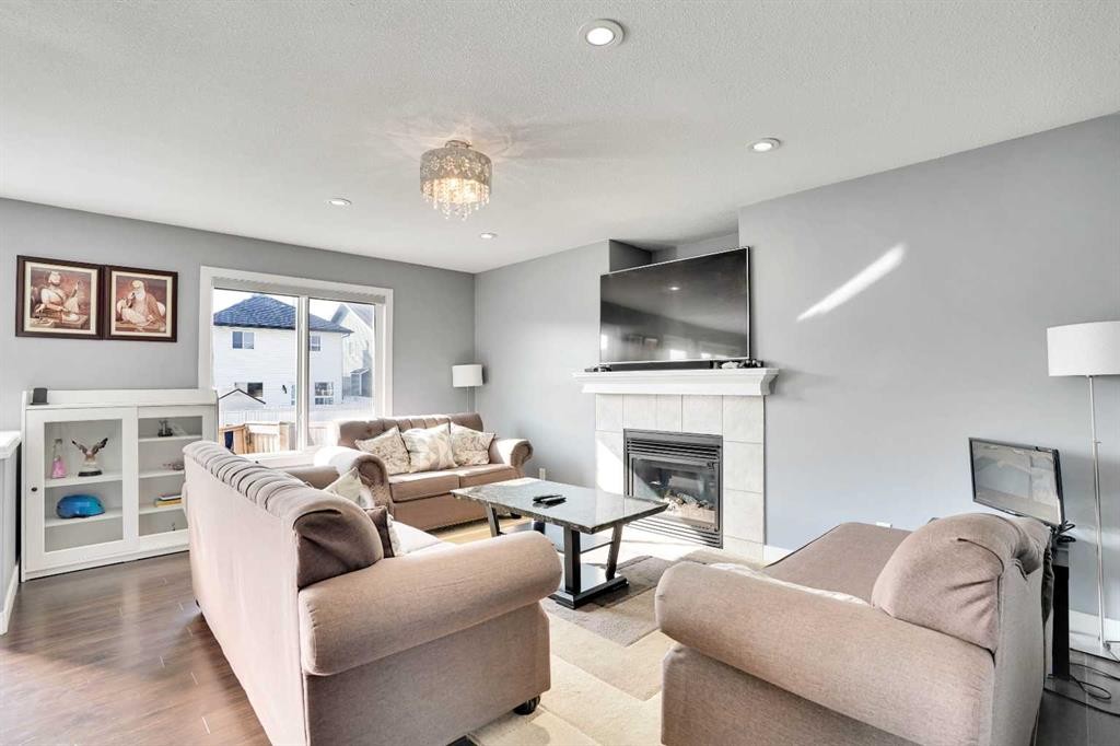 151 Saddlehorn Close Ne, Calgary, AB - Indoor Photo Showing Living Room With Fireplace