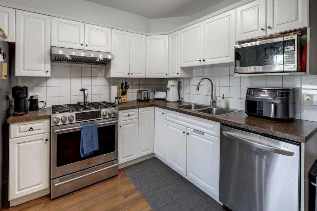 8034 24 Street Se, Calgary, AB - Indoor Photo Showing Kitchen With Double Sink