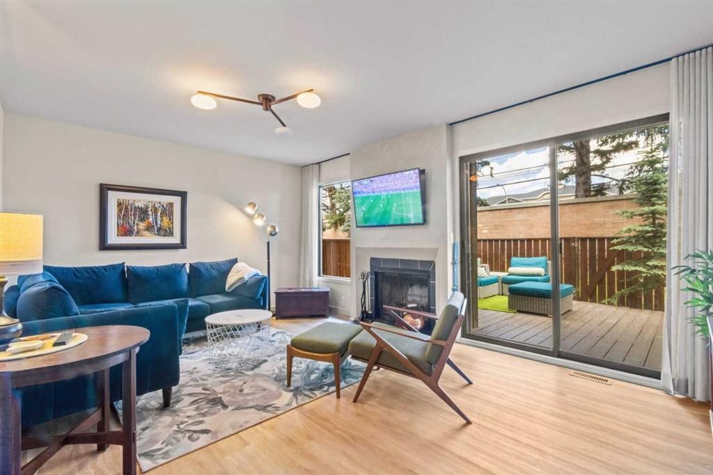16-140 Point Drive Nw, Calgary, AB - Indoor Photo Showing Living Room With Fireplace