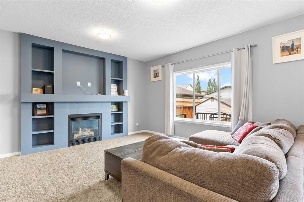 106 Morningside Circle Sw, Airdrie, AB - Indoor Photo Showing Living Room With Fireplace
