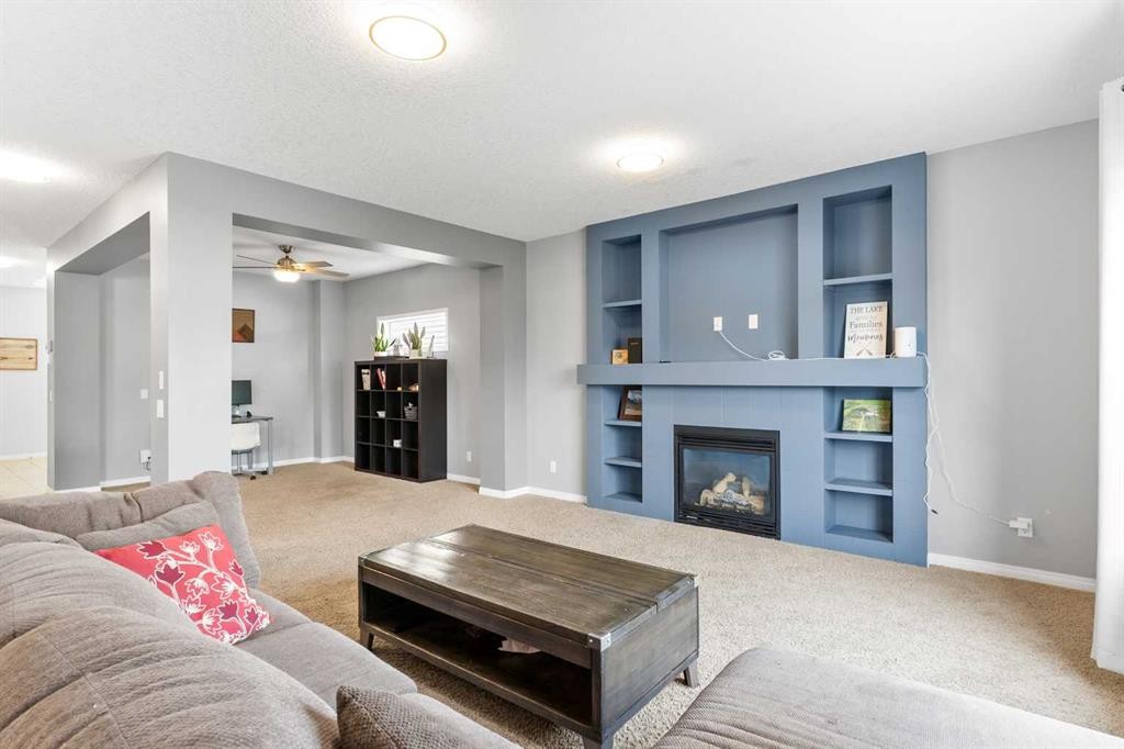 106 Morningside Circle Sw, Airdrie, AB - Indoor Photo Showing Living Room With Fireplace