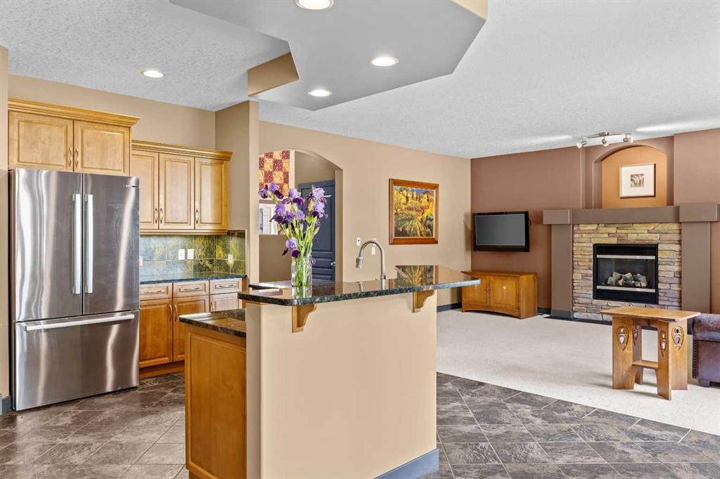 139 Tuscany Ridge Close Nw, Calgary, AB - Indoor Photo Showing Kitchen With Fireplace With Stainless Steel Kitchen