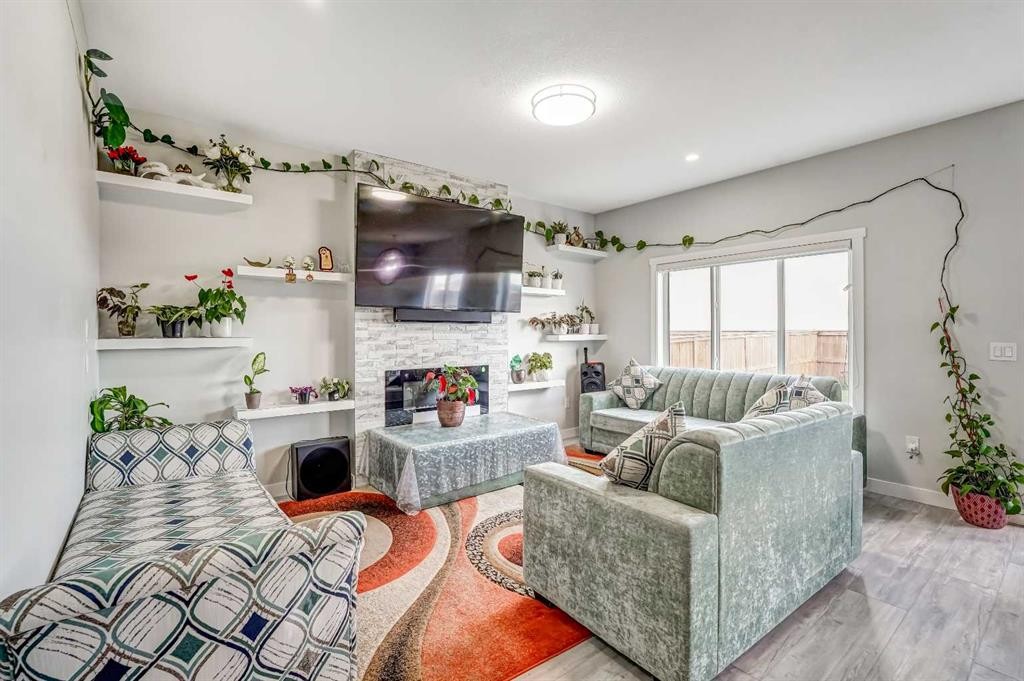 349 Corner Meadows Way Ne, Calgary, AB - Indoor Photo Showing Living Room With Fireplace